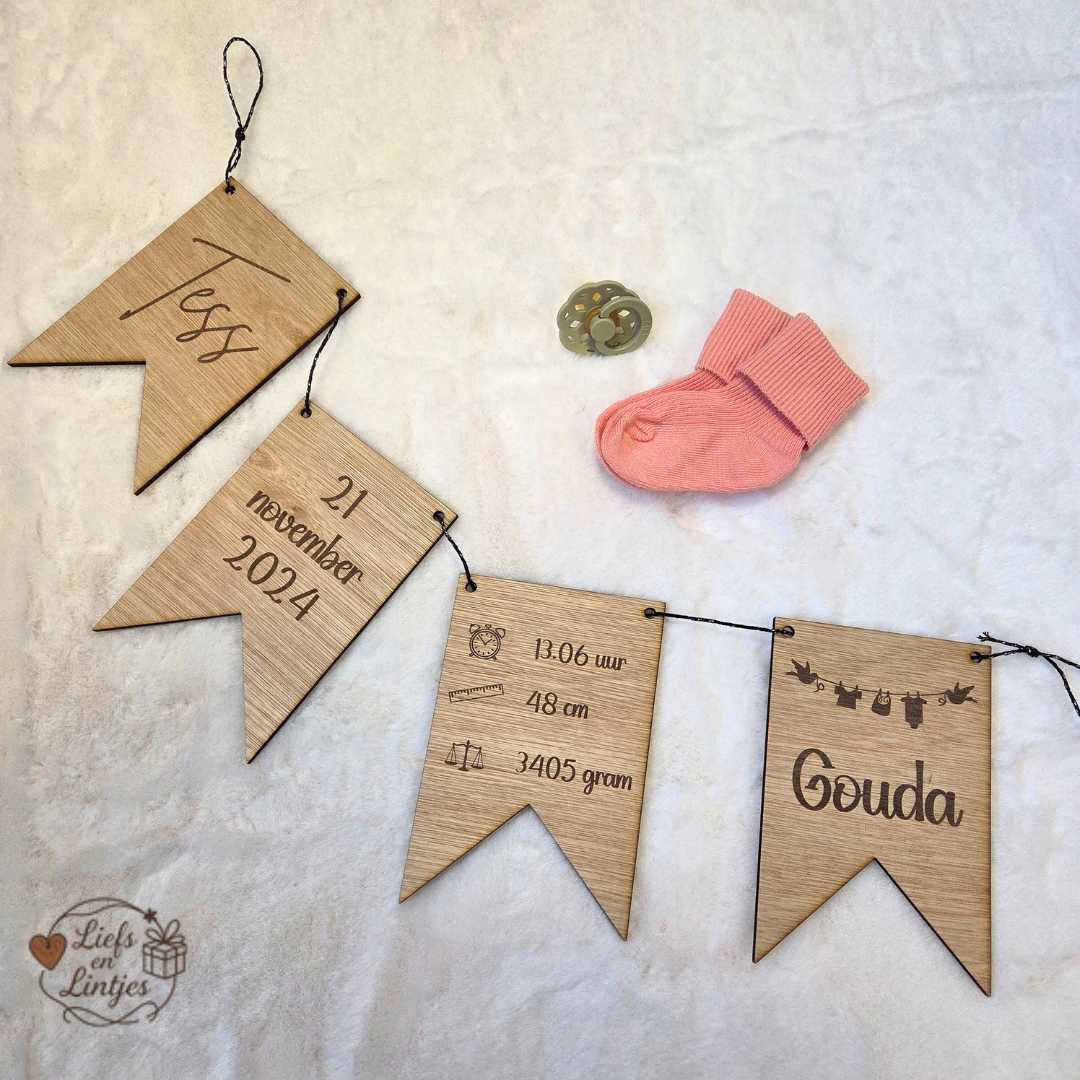 Een gepersonaliseerde houten geboorteslinger met vlaggetjes en geboortegegevens. Uniek kraamcadeau of aandenken voor de babykamer. Inclusief optie voor geboorteplaats of kaartje.