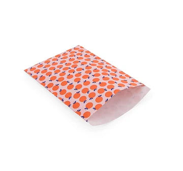 Cadeauzakje XL met oranje sinaasappeltjes op roze achtergrond – Liefs en Lintjes